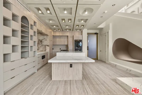 a kitchen with stainless steel appliances a stove a sink and a refrigerator