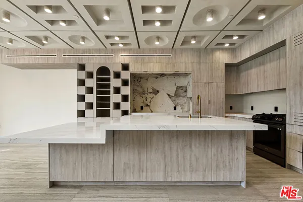 a kitchen with a sink a stove and cabinets