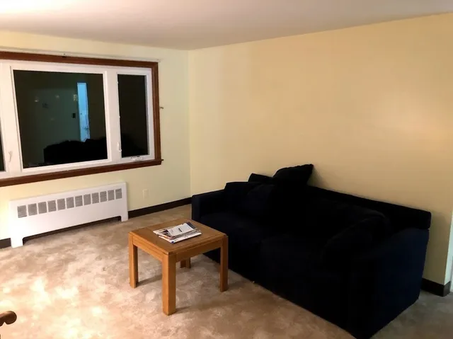 a view of a bedroom with furniture and a window