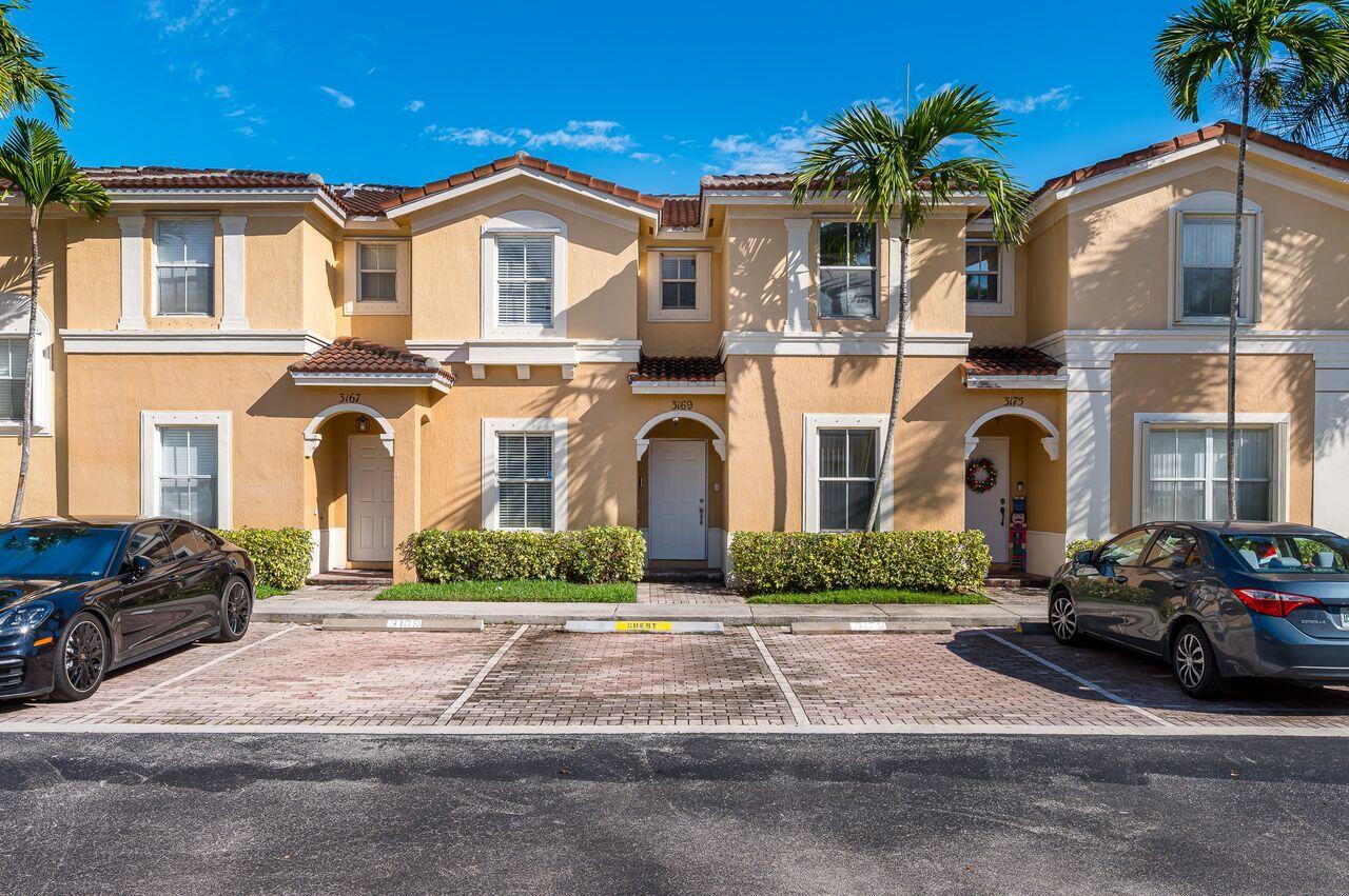3169 Southwest 129th Terrace, Unit 164 Miramar, FL 33027 - Photo 2 of 20 a front view of a house with a yard