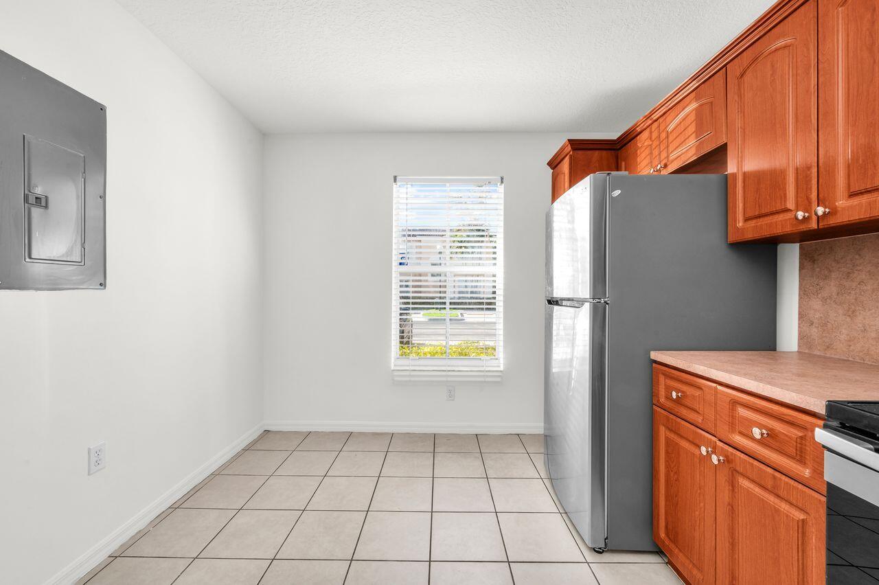 3169 Southwest 129th Terrace, Unit 164 Miramar, FL 33027 - Photo 6 of 20 a utility room with closet a window and a shower