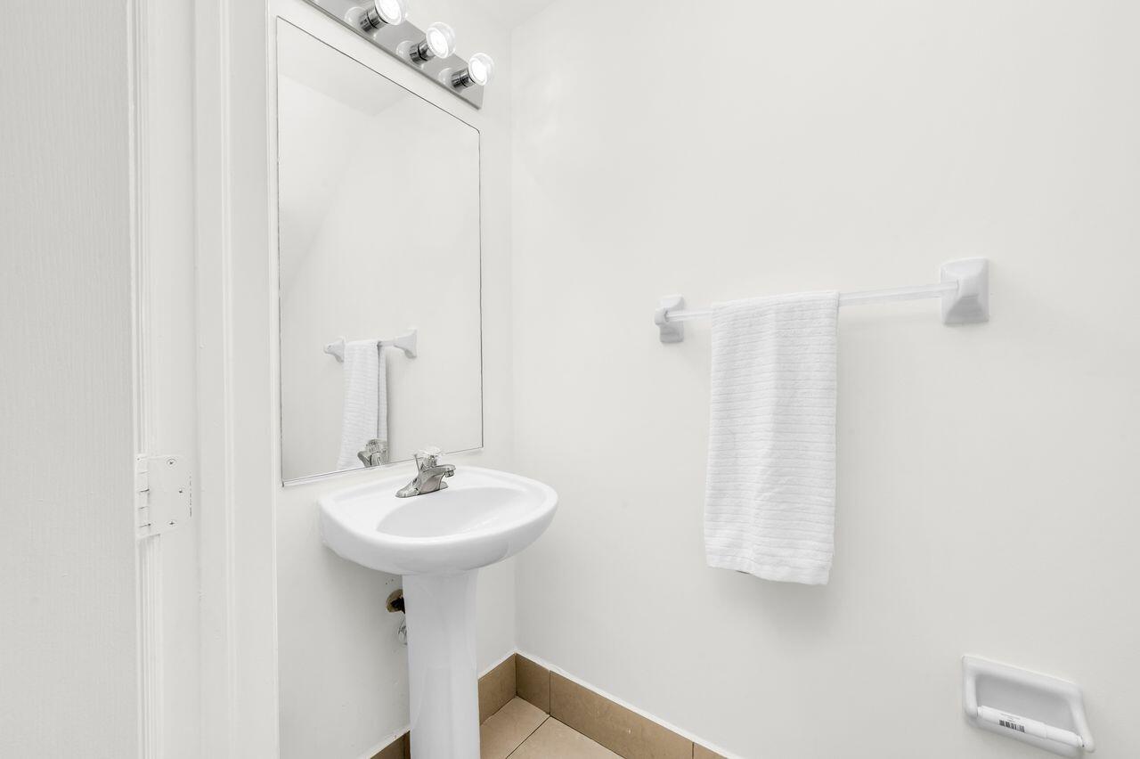 3169 Southwest 129th Terrace, Unit 164 Miramar, FL 33027 - Photo 7 of 20 a bathroom with a sink a mirror and shower