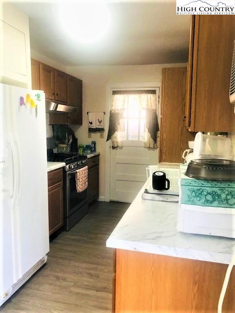 786 Teaberry Road Warrensville, NC 28693 - Photo 16 of 35 a kitchen with a stove a sink and a refrigerator