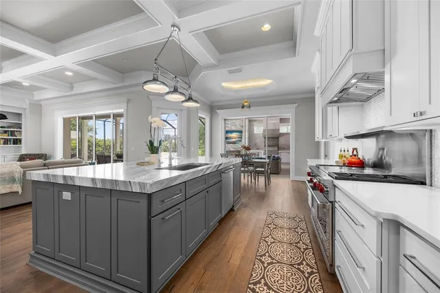 a white bath tub sitting next to a white sink and vanity