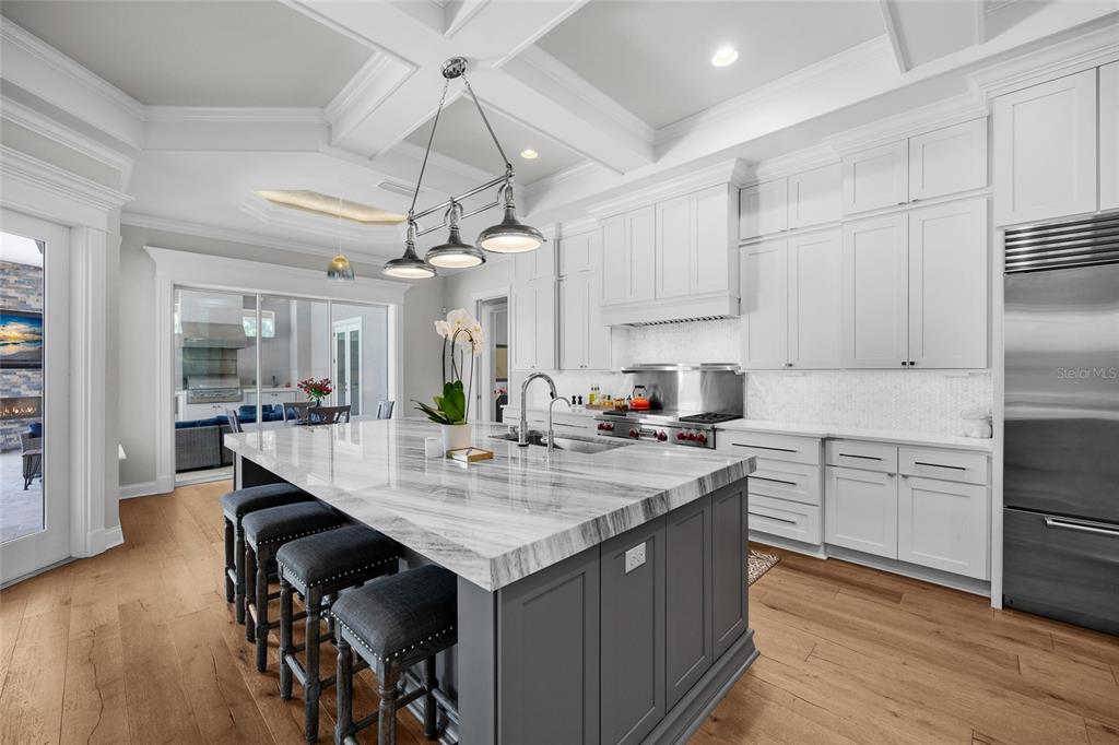 11372 Southwest 30th Avenue Gainesville, FL 32608 - Photo 18 of 71 a kitchen with kitchen island granite countertop a sink cabinets and wooden floor