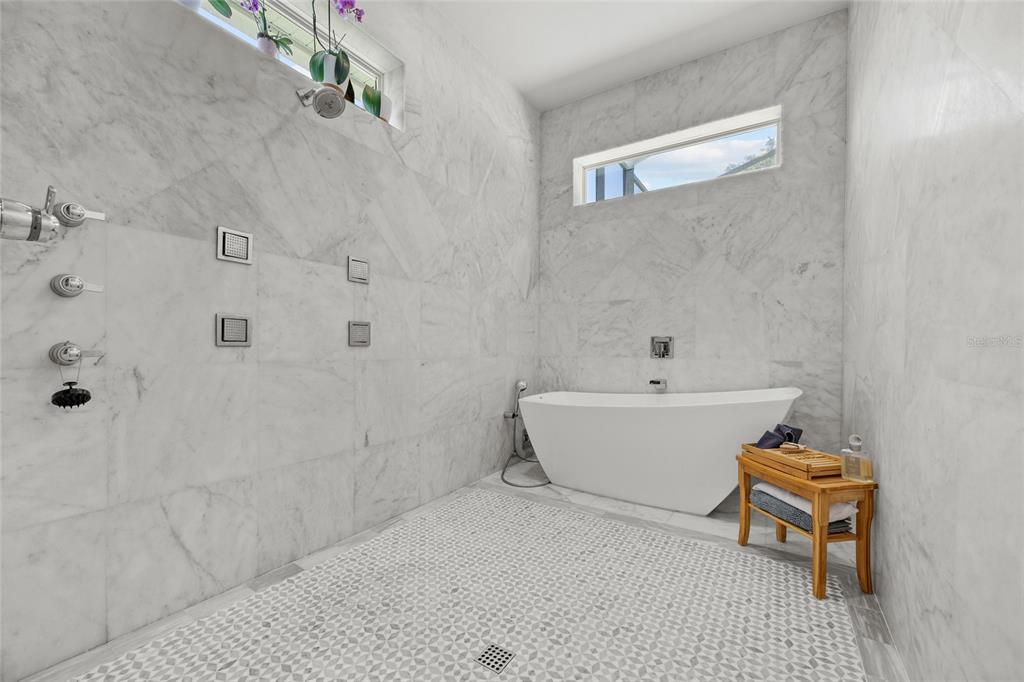 11372 Southwest 30th Avenue Gainesville, FL 32608 - Photo 26 of 71 a white bath tub sitting next to a white sink and vanity