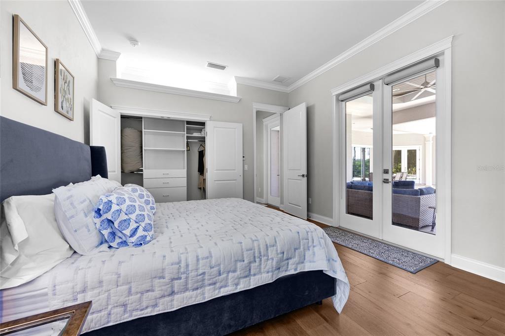 11372 Southwest 30th Avenue Gainesville, FL 32608 - Photo 28 of 71 a bedroom with a large bed and a chandelier