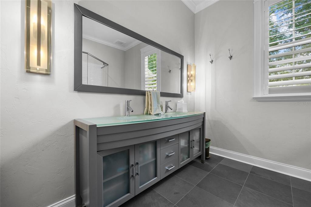 11372 Southwest 30th Avenue Gainesville, FL 32608 - Photo 30 of 71 a bathroom with a sink a vanity and a mirror