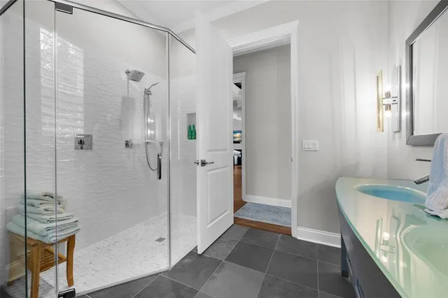 a bedroom with a bed and a large mirror next to a window