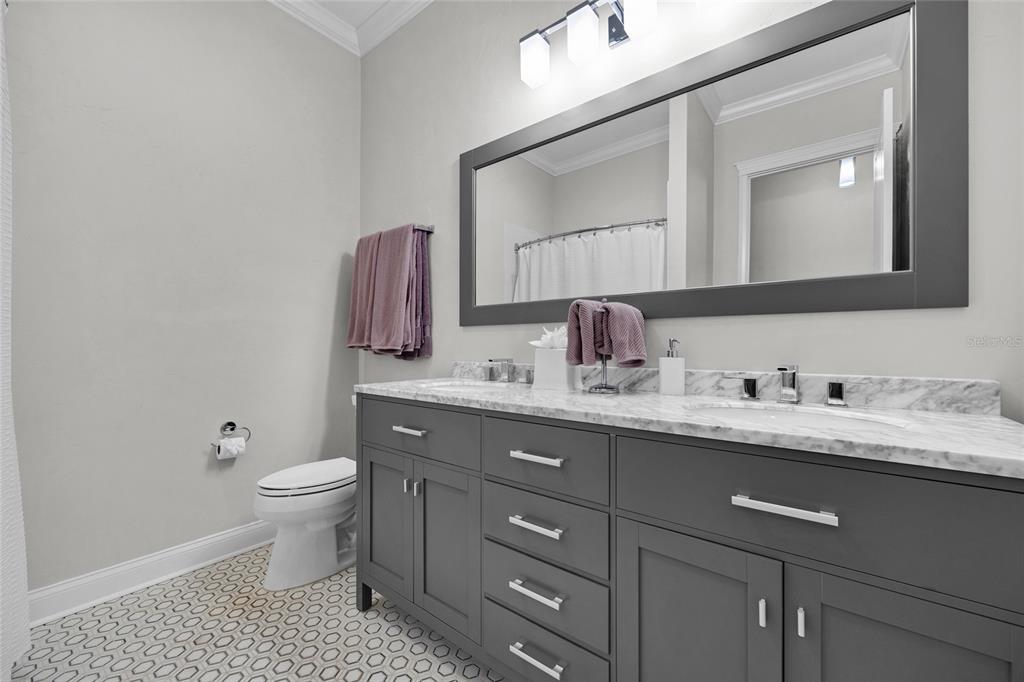 11372 Southwest 30th Avenue Gainesville, FL 32608 - Photo 35 of 71 a bathroom with a toilet a sink and mirror