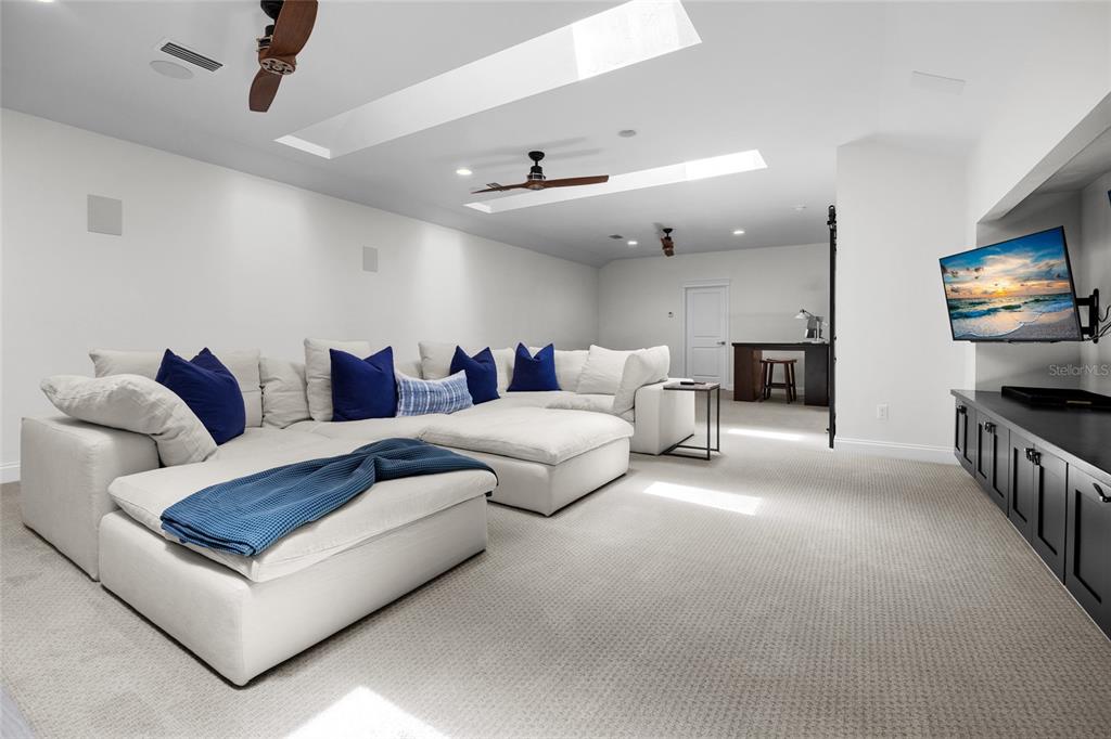 11372 Southwest 30th Avenue Gainesville, FL 32608 - Photo 37 of 71 a living room with furniture and a flat screen tv