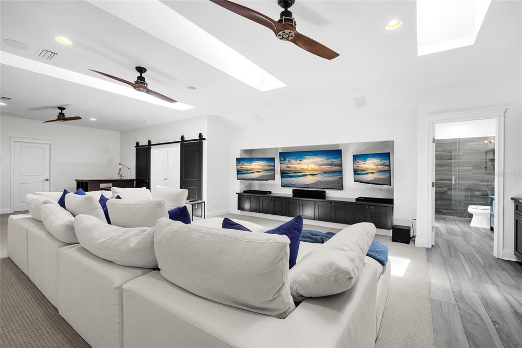 11372 Southwest 30th Avenue Gainesville, FL 32608 - Photo 38 of 71 a living room with furniture and a flat screen tv