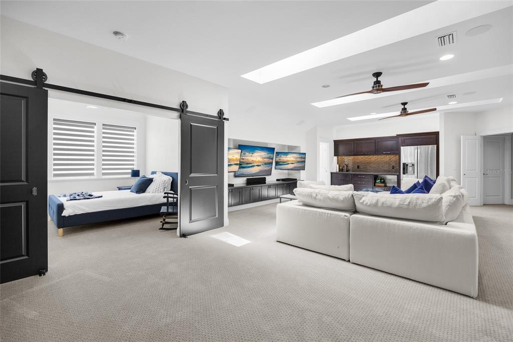 11372 Southwest 30th Avenue Gainesville, FL 32608 - Photo 40 of 71 a living room with furniture and a flat screen tv