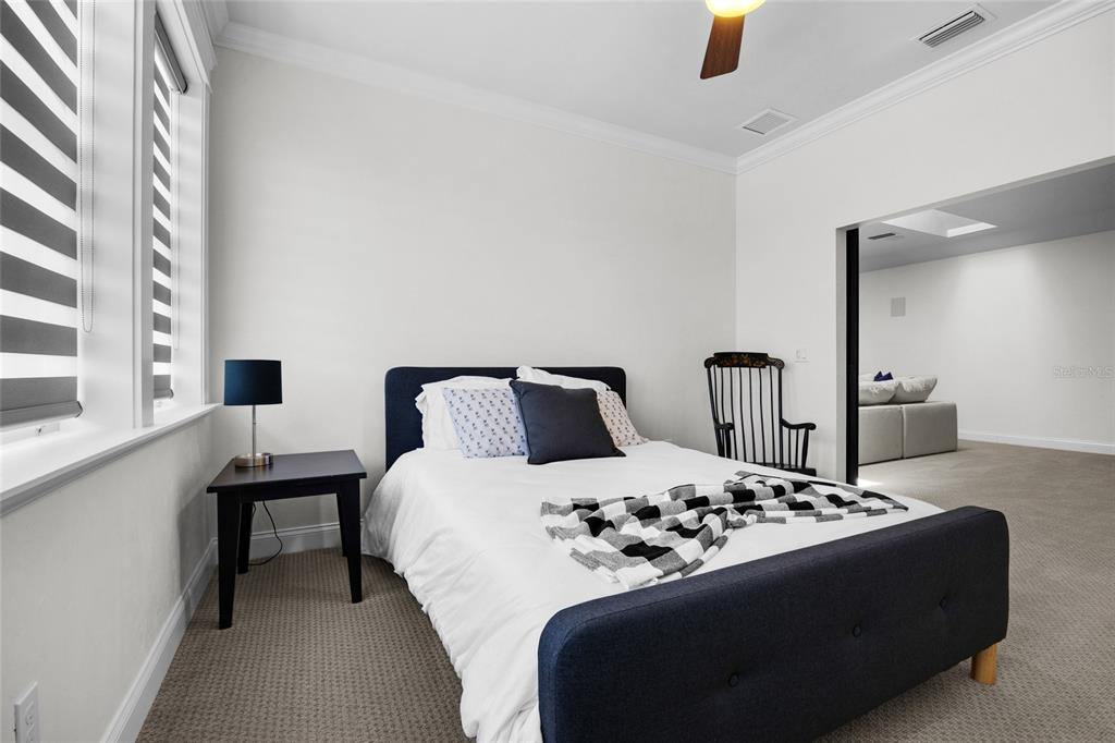 11372 Southwest 30th Avenue Gainesville, FL 32608 - Photo 41 of 71 a bedroom with a bed and a large mirror next to a window