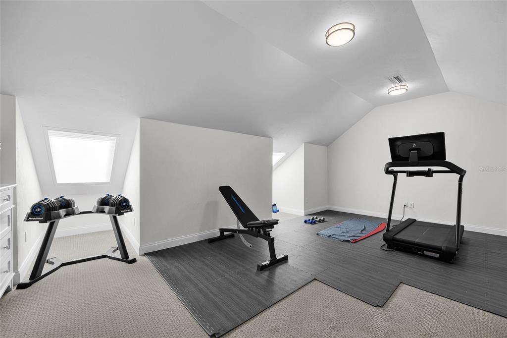 11372 Southwest 30th Avenue Gainesville, FL 32608 - Photo 43 of 71 a room with gym equipment and a wooden floor