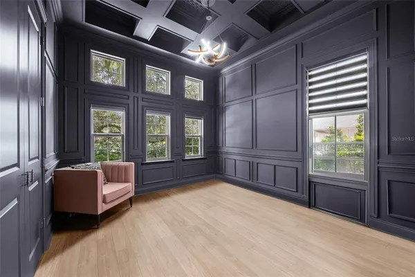 a living room with furniture flat screen tv and window