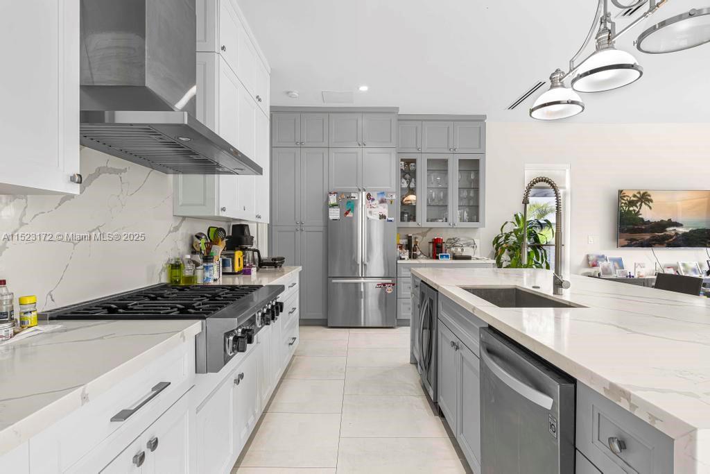 Coral Terrace Miami, FL 33155 - Photo 10 of 51 a kitchen with stainless steel appliances a sink stove and cabinets