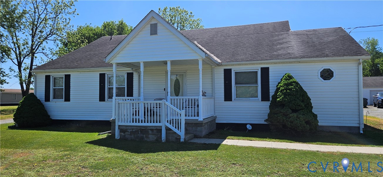 1025 Sunnyside Road Tappahannock, VA 22560 - Photo 2 of 5 a front view of a house with garden