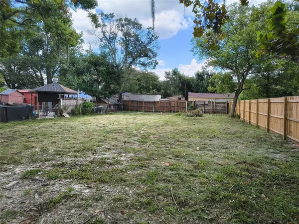 a view of a house with yard and sitting area