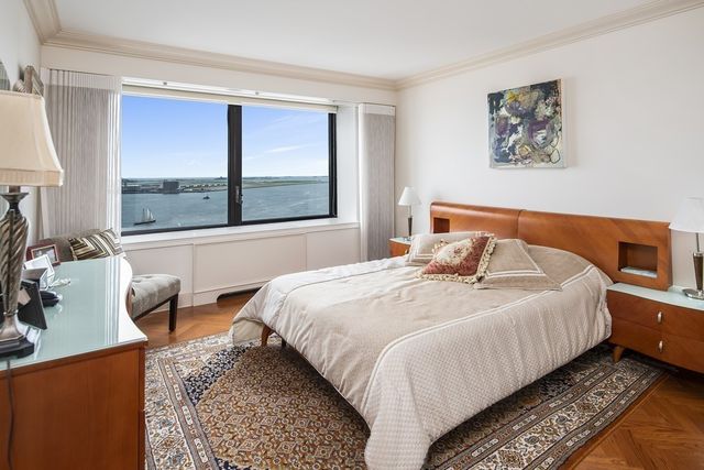 a bedroom with furniture and a large window