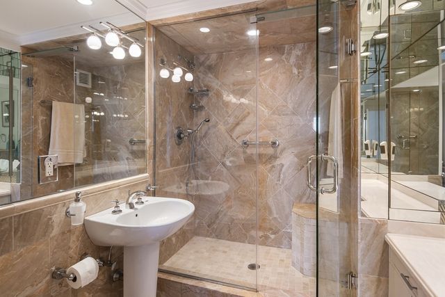 a bedroom with a bed and large windows