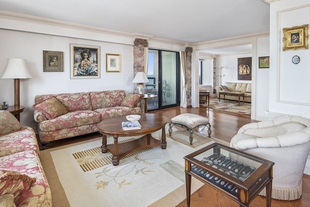 a living room with furniture a rug and a lamp