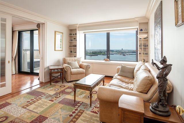 a living room with furniture and a floor to ceiling window