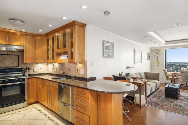 a kitchen with stainless steel appliances granite countertop a sink and stove