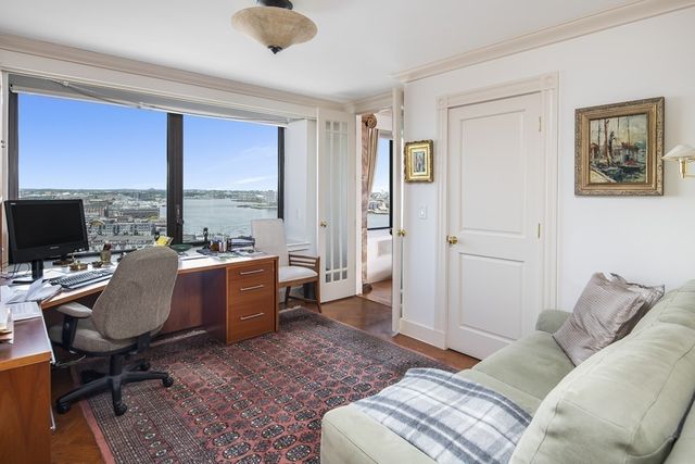 a view of a livingroom with workspace and a window