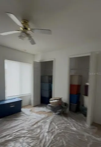 a view of a livingroom with a furniture and a ceiling fan