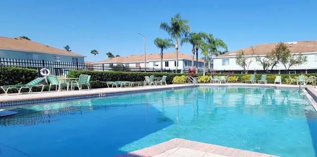 a view of swimming pool with outdoor seating and city view