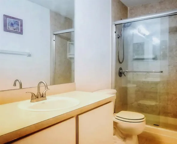 a bathroom with a sink toilet and shower
