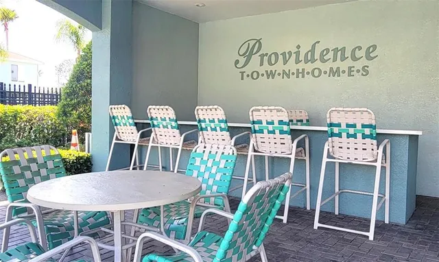 a view of a chairs and table in patio