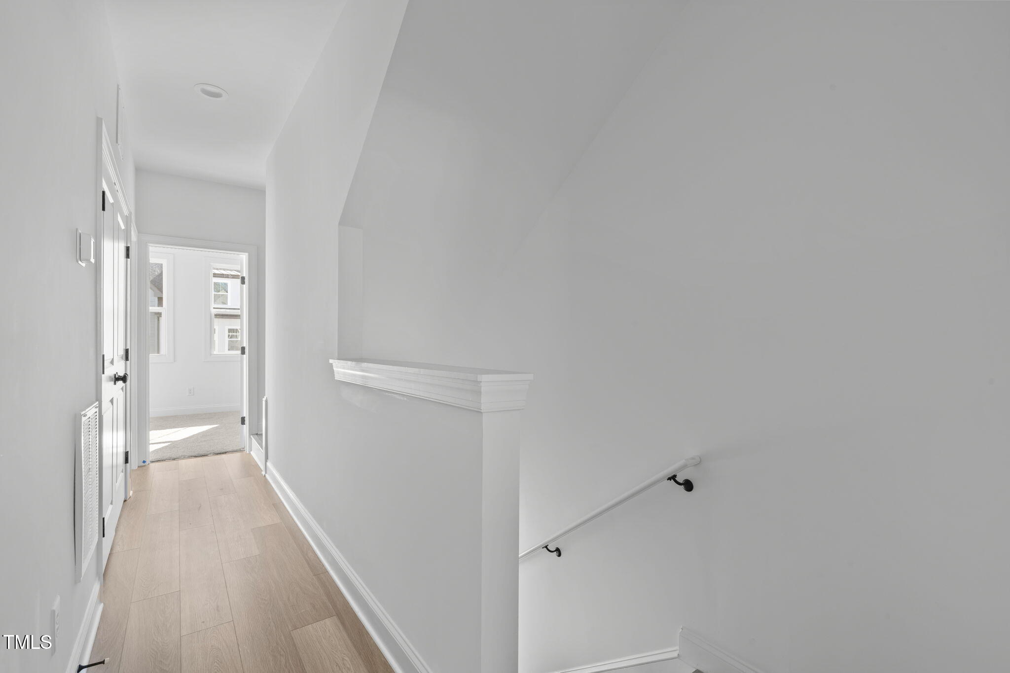 4811 Gossamer Lane, Unit 106 Raleigh, NC 27616 - Photo 13 of 42 a view of a hallway with wooden floor and a bathroom