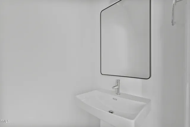a bathroom with a sink and mirror