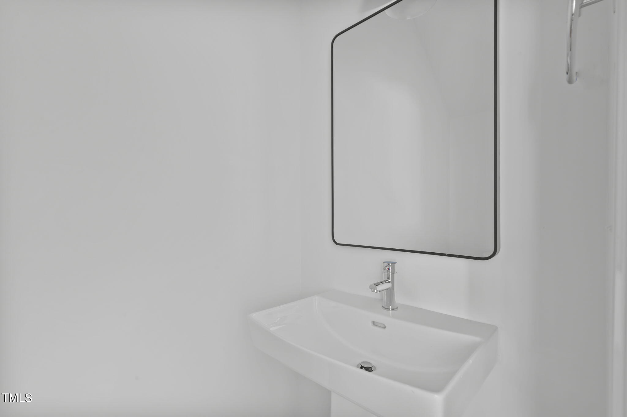 4811 Gossamer Lane, Unit 106 Raleigh, NC 27616 - Photo 24 of 42 a bathroom with a sink and mirror