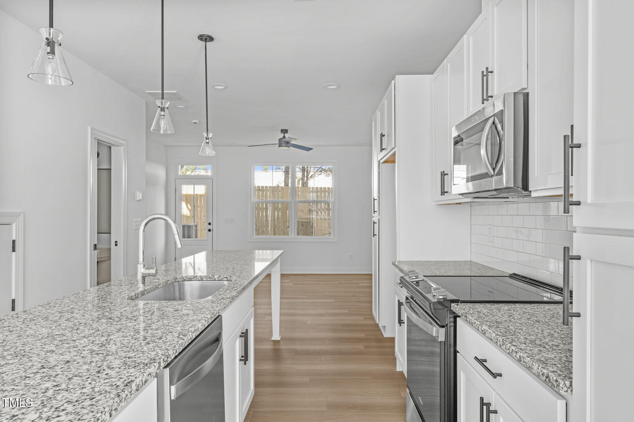 4811 Gossamer Lane, Unit 106 Raleigh, NC 27616 - Photo 5 of 42 a kitchen with stainless steel appliances granite countertop a sink stove and refrigerator