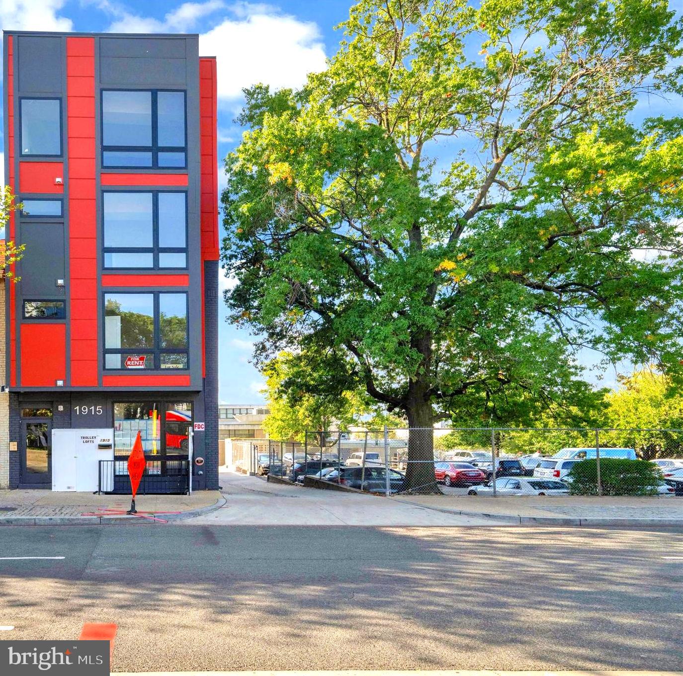 1915 Benning Road Northeast Washington, DC 20002 - Photo 1 of 22 a building with trees in front of it