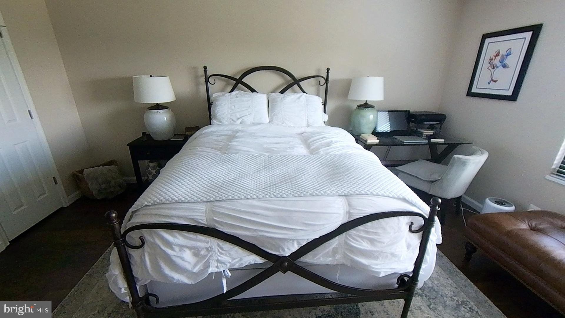 1915 Benning Road Northeast Washington, DC 20002 - Photo 13 of 22 a bedroom with a bed and a lamp on table