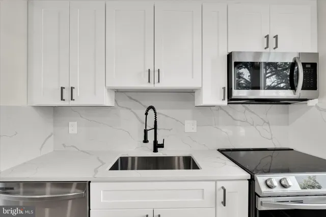 a kitchen with a sink and cabinets