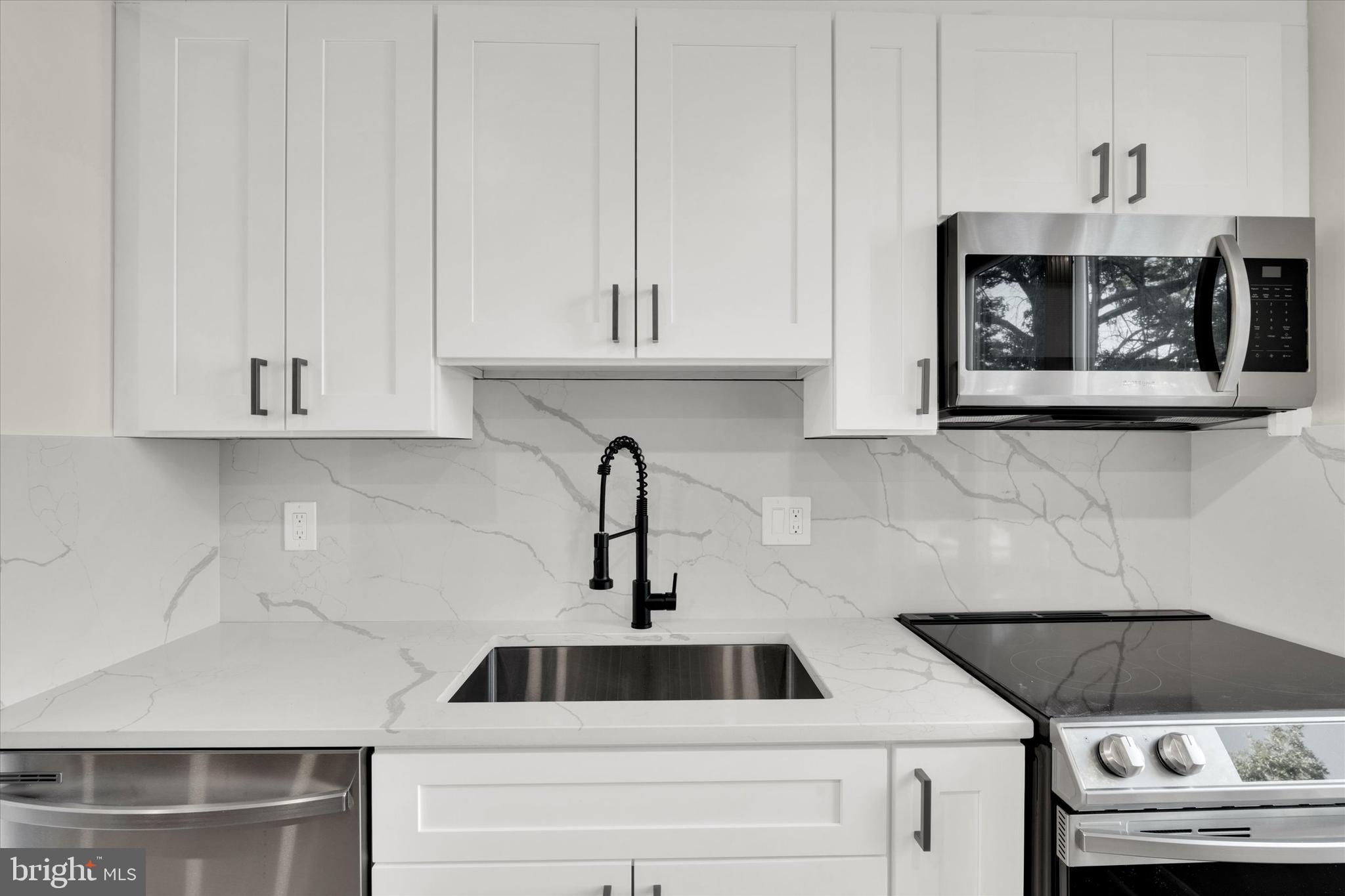 1915 Benning Road Northeast Washington, DC 20002 - Photo 10 of 22 a kitchen with a sink and cabinets