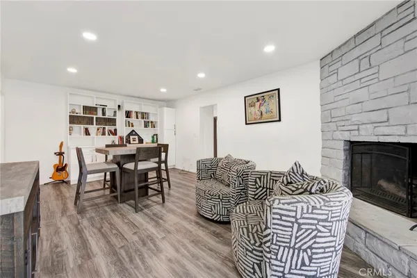 a living room with furniture a fireplace and wooden floor