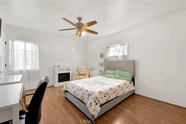 a bedroom with a bed a chandelier and a window
