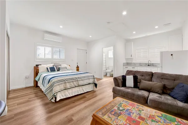 a spacious bedroom with a bed a couch and a window