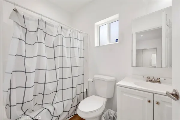 a white toilet sitting next to a bathroom sink