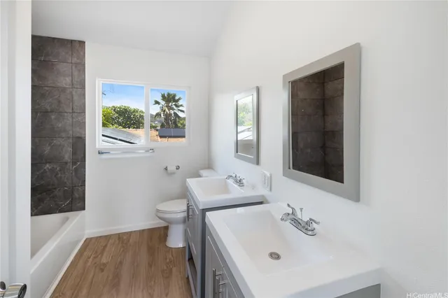 a bathroom with a sink and mirror with toilet