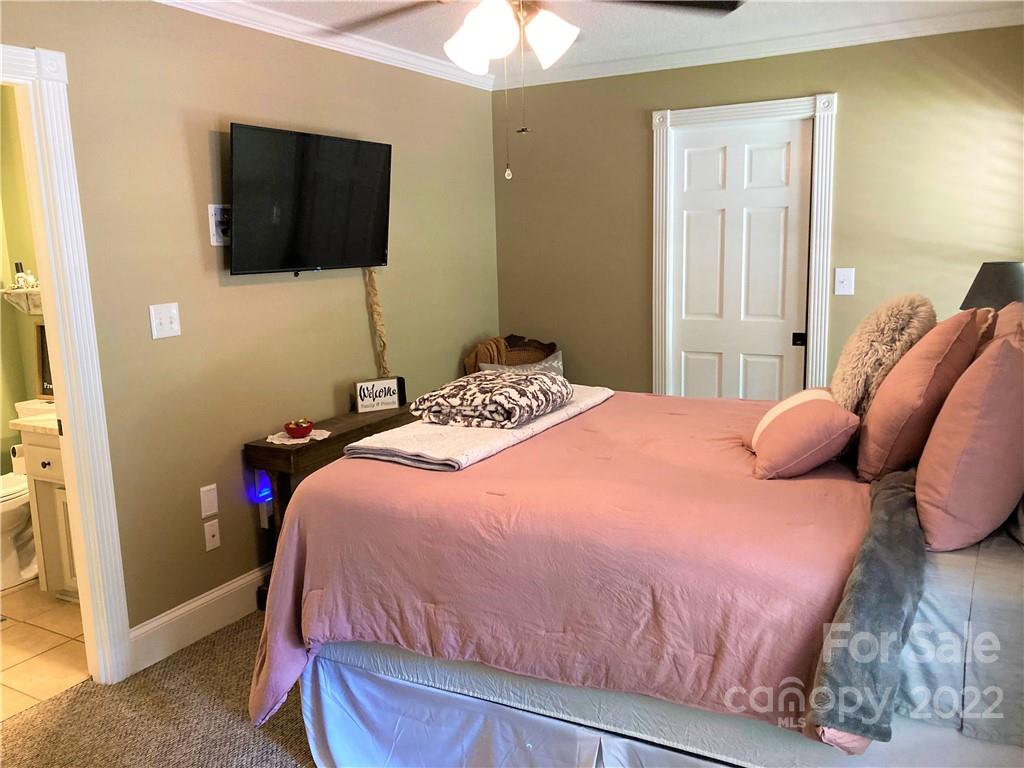 1258 South Mountain Road Bostic, NC 28018 - Photo 23 of 48 a bedroom with a bed and a flat screen tv
