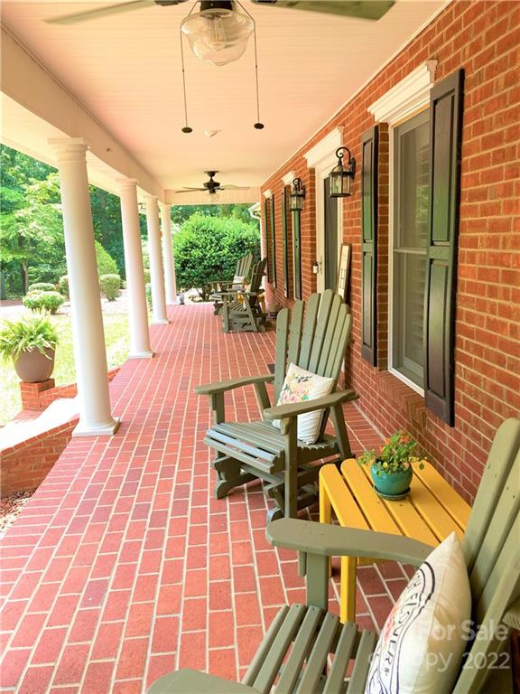 1258 South Mountain Road Bostic, NC 28018 - Photo 39 of 48 a view of a patio with table and chairs with wooden floor and fence