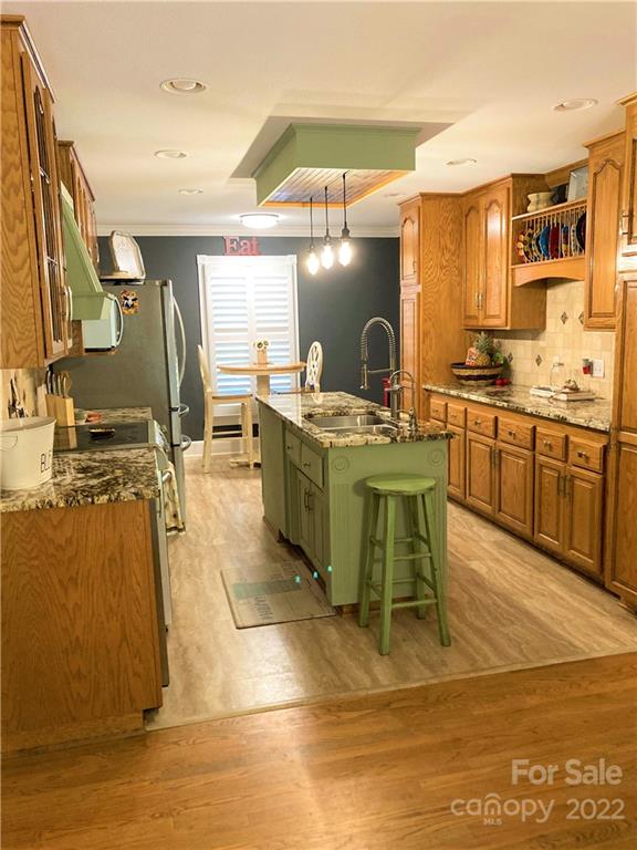 1258 South Mountain Road Bostic, NC 28018 - Photo 8 of 48 a room with stainless steel appliances kitchen island granite countertop a sink and cabinets