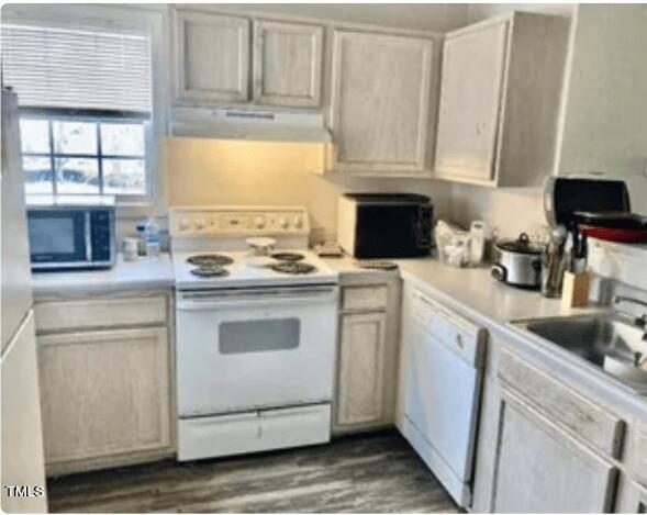 2011 Wolfmill Drive, Unit 301 Raleigh, NC 27603 - Photo 3 of 6 a kitchen with granite countertop white cabinets and white appliances
